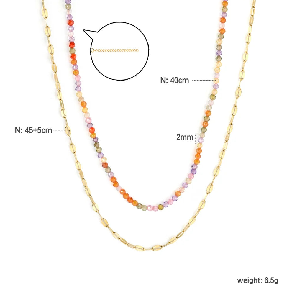 Multicolored beaded necklace with gold chain on a white background