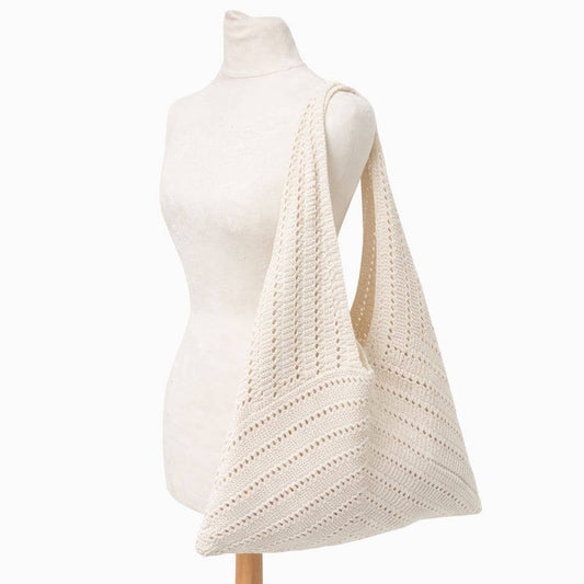 White knitted bag on a mannequin against a white background