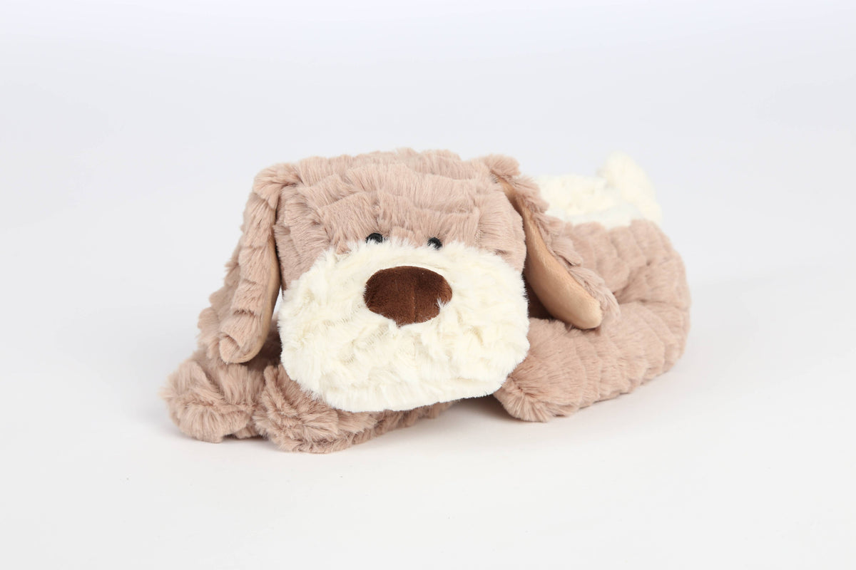 A plush dog toy in soft tan and cream colors, photographed on a seamless white studio background.