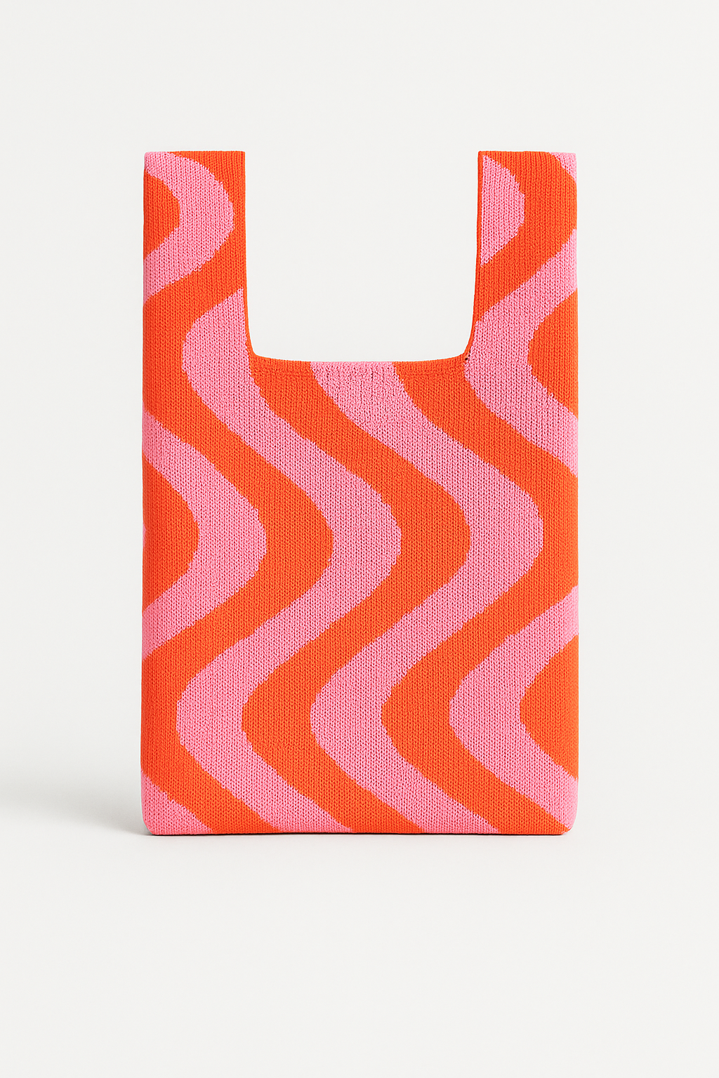Woven bag with pink and orange wavy pattern on a white background