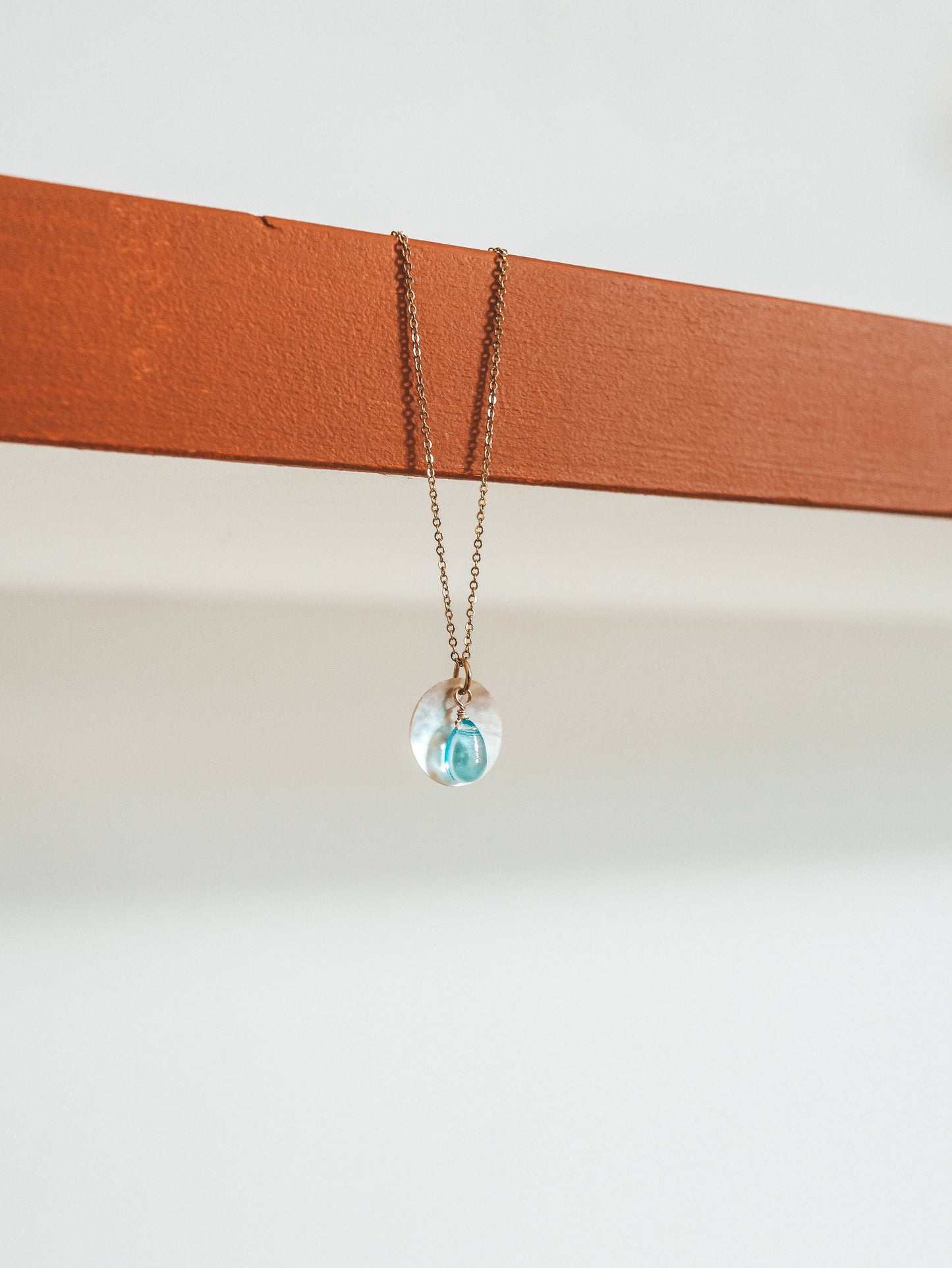 Necklace with a clear pendant on a white background