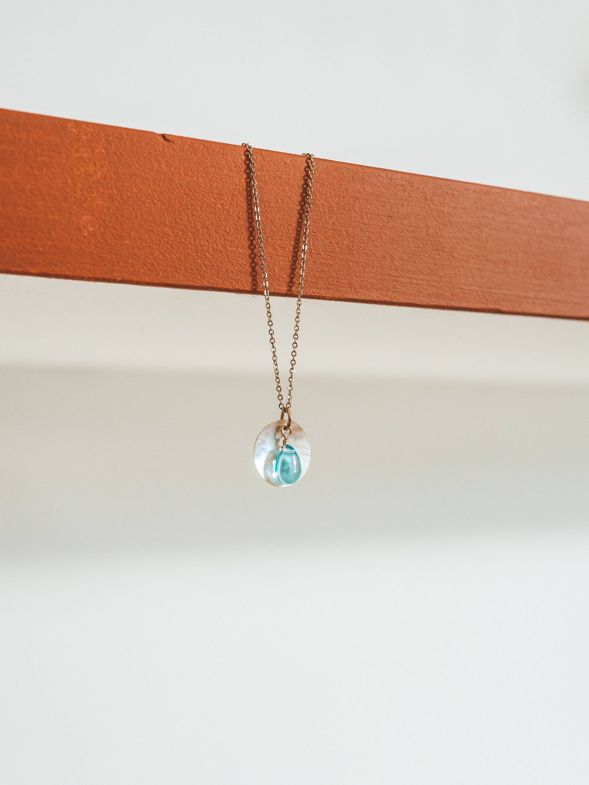 Necklace with a clear pendant on a white background