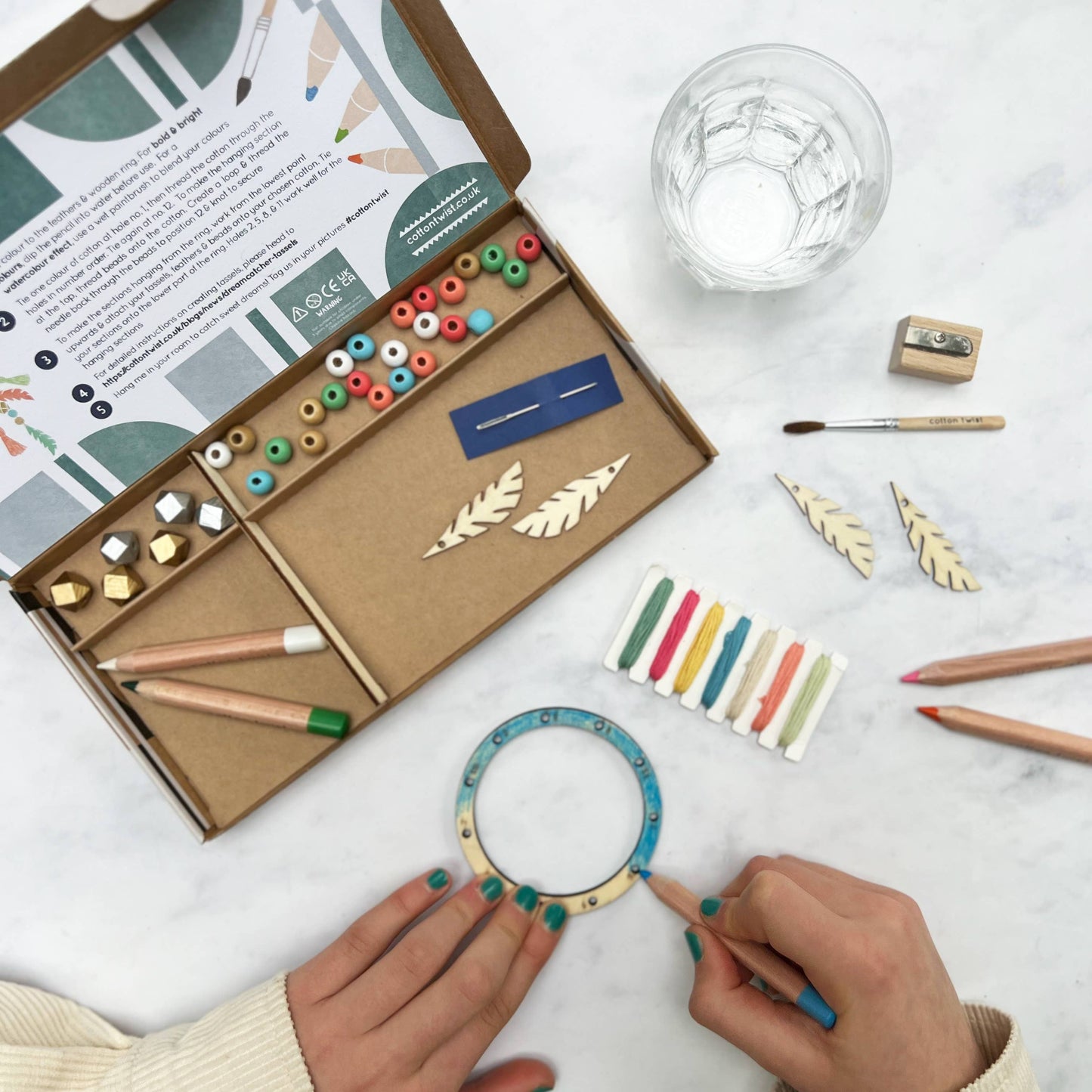 Crafting kit with tools and materials on a white surface
