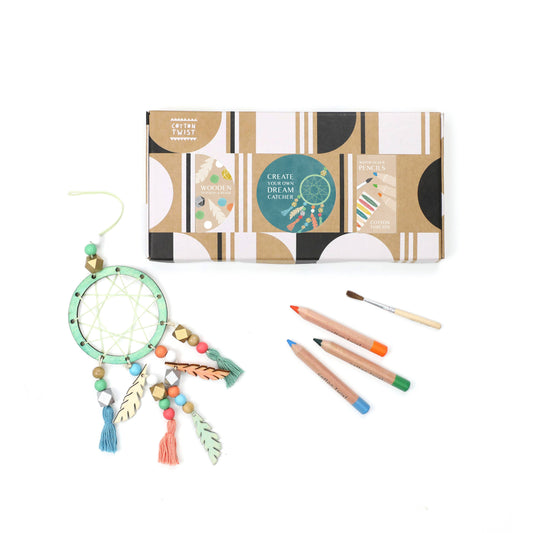 Dream catcher kit with packaging, feathers, and colored pencils on a white background