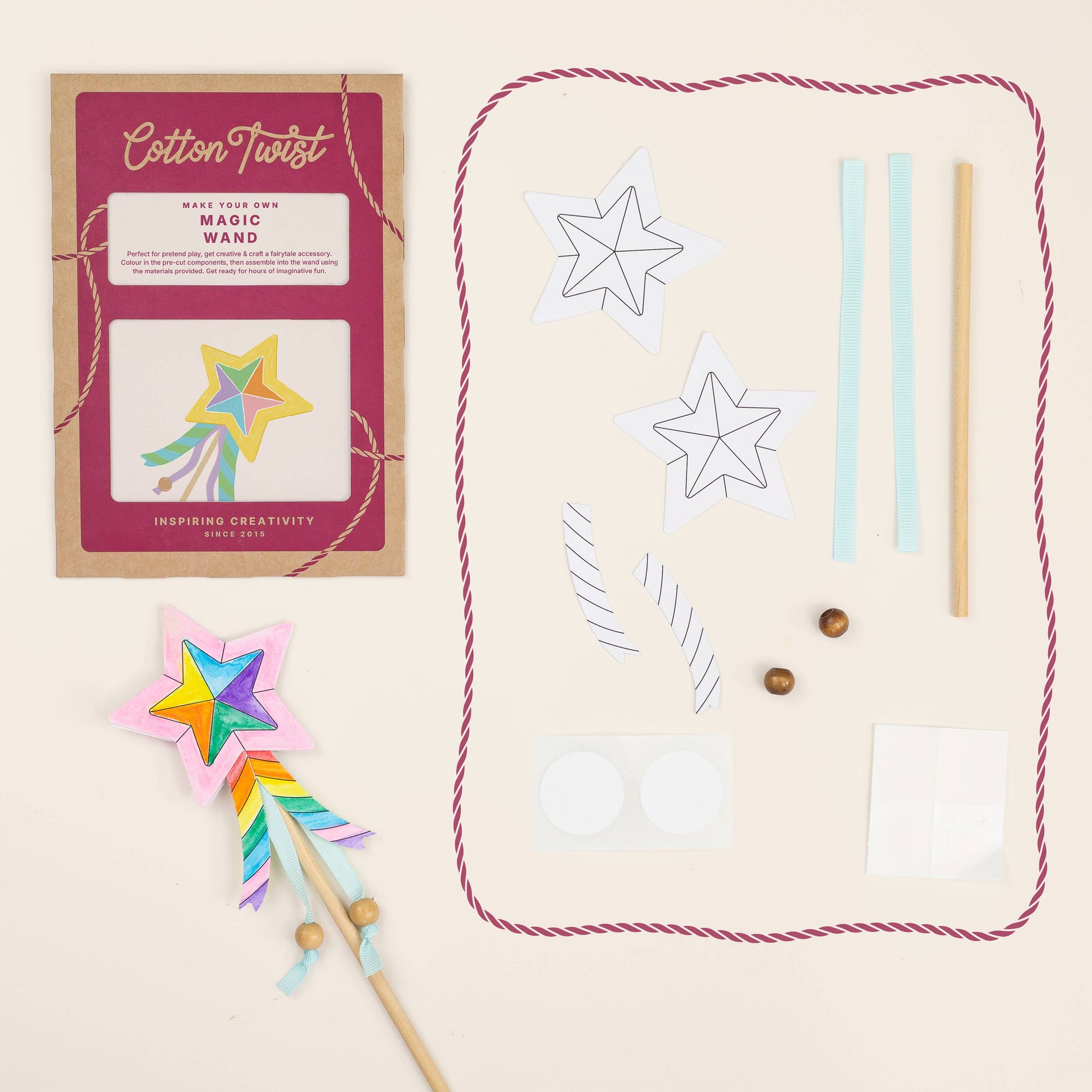 Cotton Twist craft kit with star-shaped wand, paper templates, and wooden beads on a beige background.