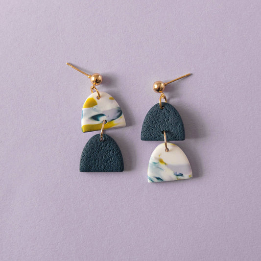 Handmade polymer clay earrings in teal lilac and chartreuse tones with gold plated posts on a lilac backgound