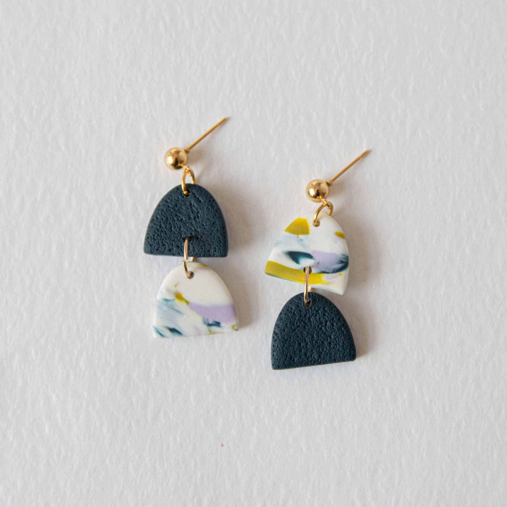 Handmade polymer clay earrings in teal lilac and chartreuse tones with gold plated posts on a white background.