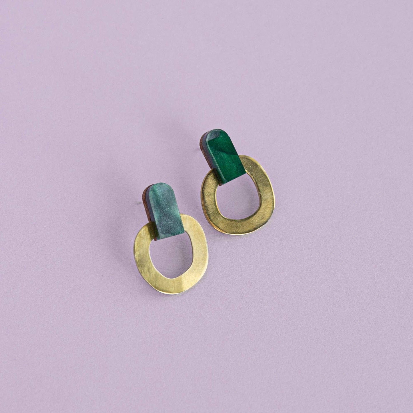 Teal brass stud earrings handmade from FSC wood, recycled brass and acrylic with nickel-free posts on lilac background