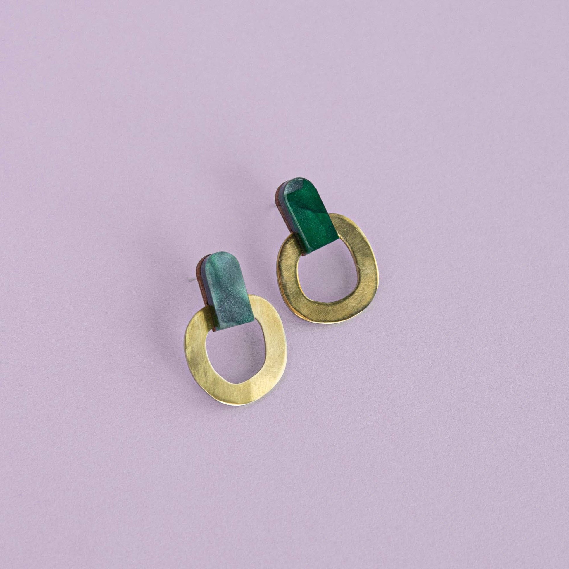 Teal brass stud earrings handmade from FSC wood, recycled brass and acrylic with nickel-free posts on lilac background
