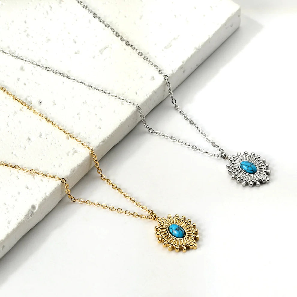 Two necklaces with turquoise pendants on a white surface