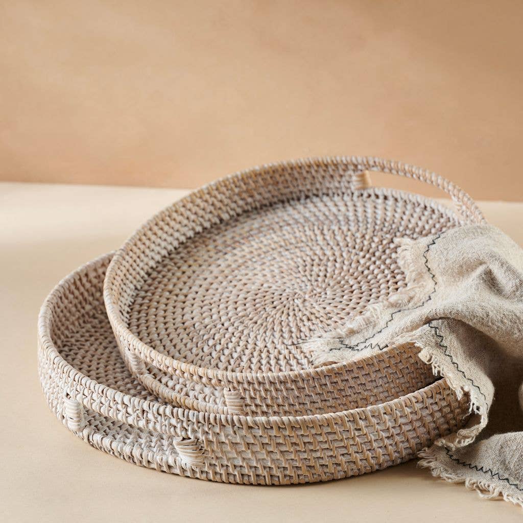 Set of woven baskets on a beige surface with a neutral background