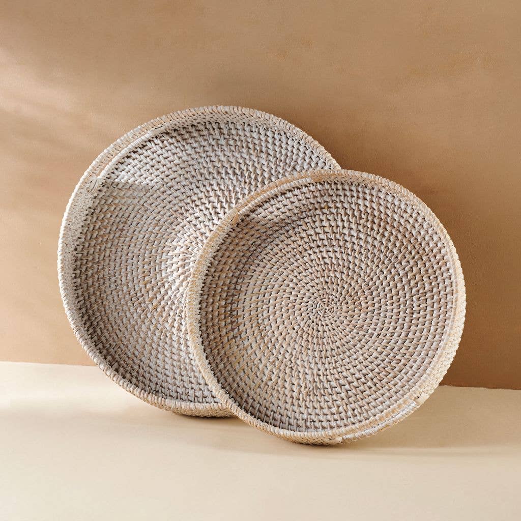 Two woven baskets on a beige surface with a beige background