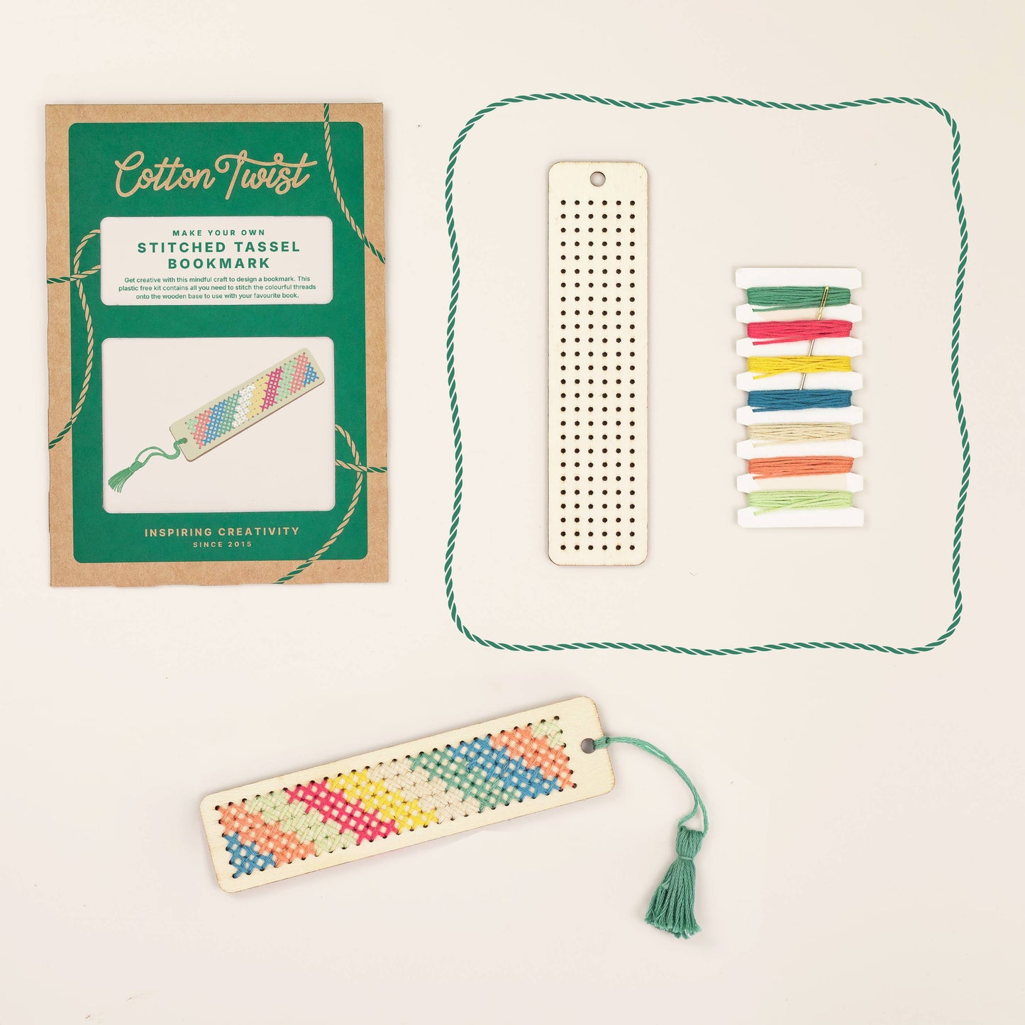 Colorful woven bookmark with tassel, loom, and packaging on a light background