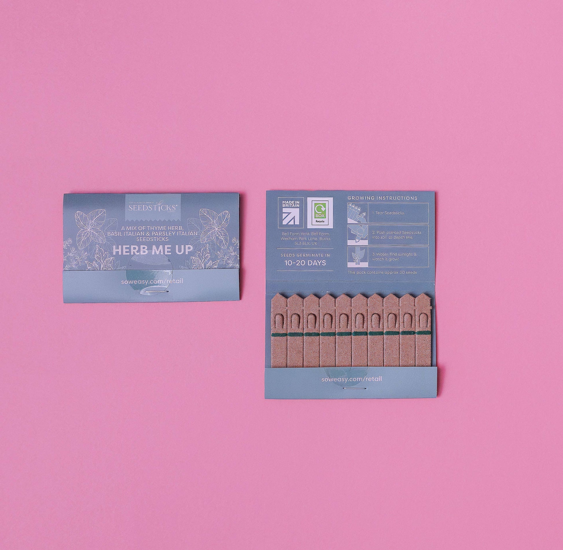Two packages labeled 'Herb Me Up' on a pink background