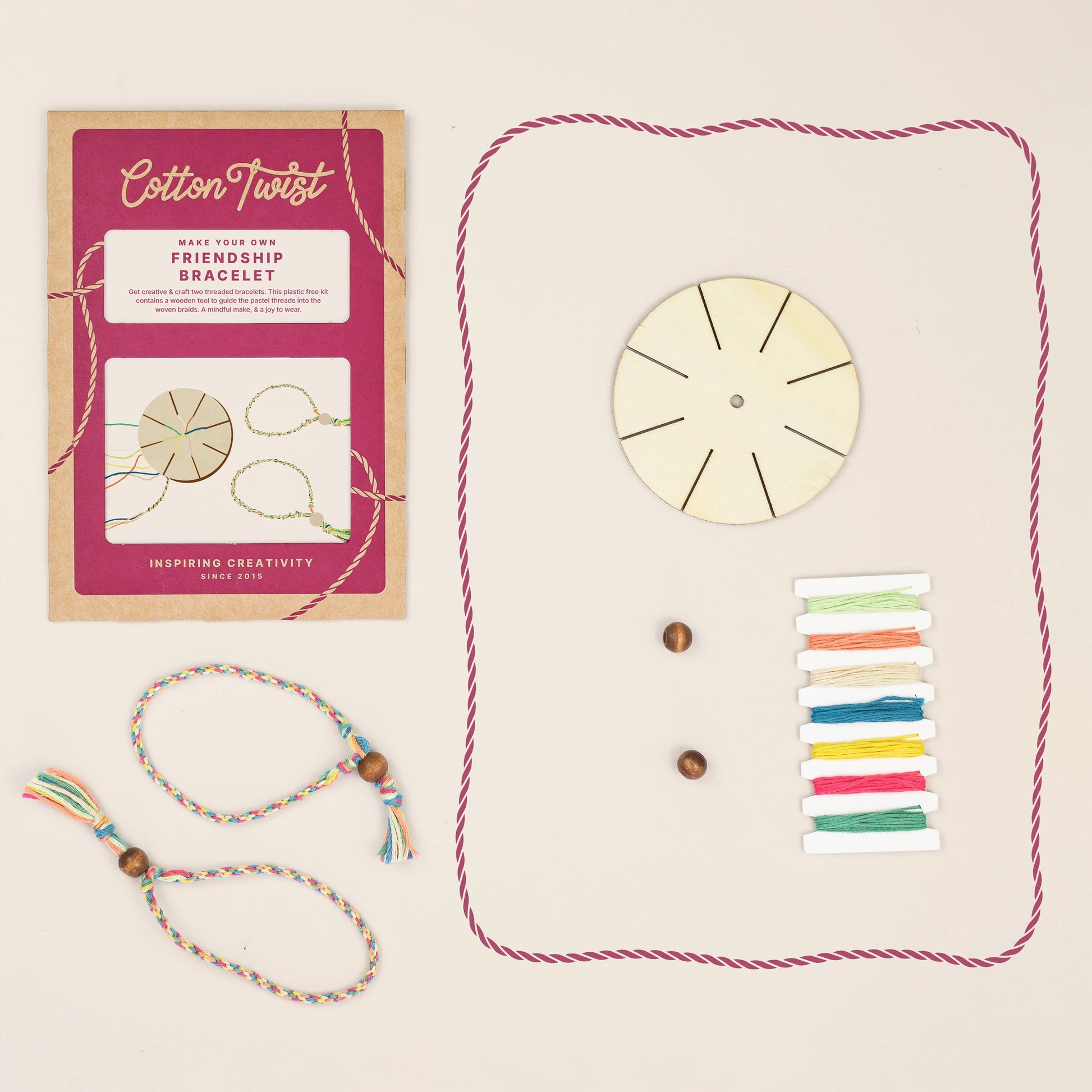 Cotton Twist friendship bracelet making kit with packaging, beads, and colorful strings on a beige background.