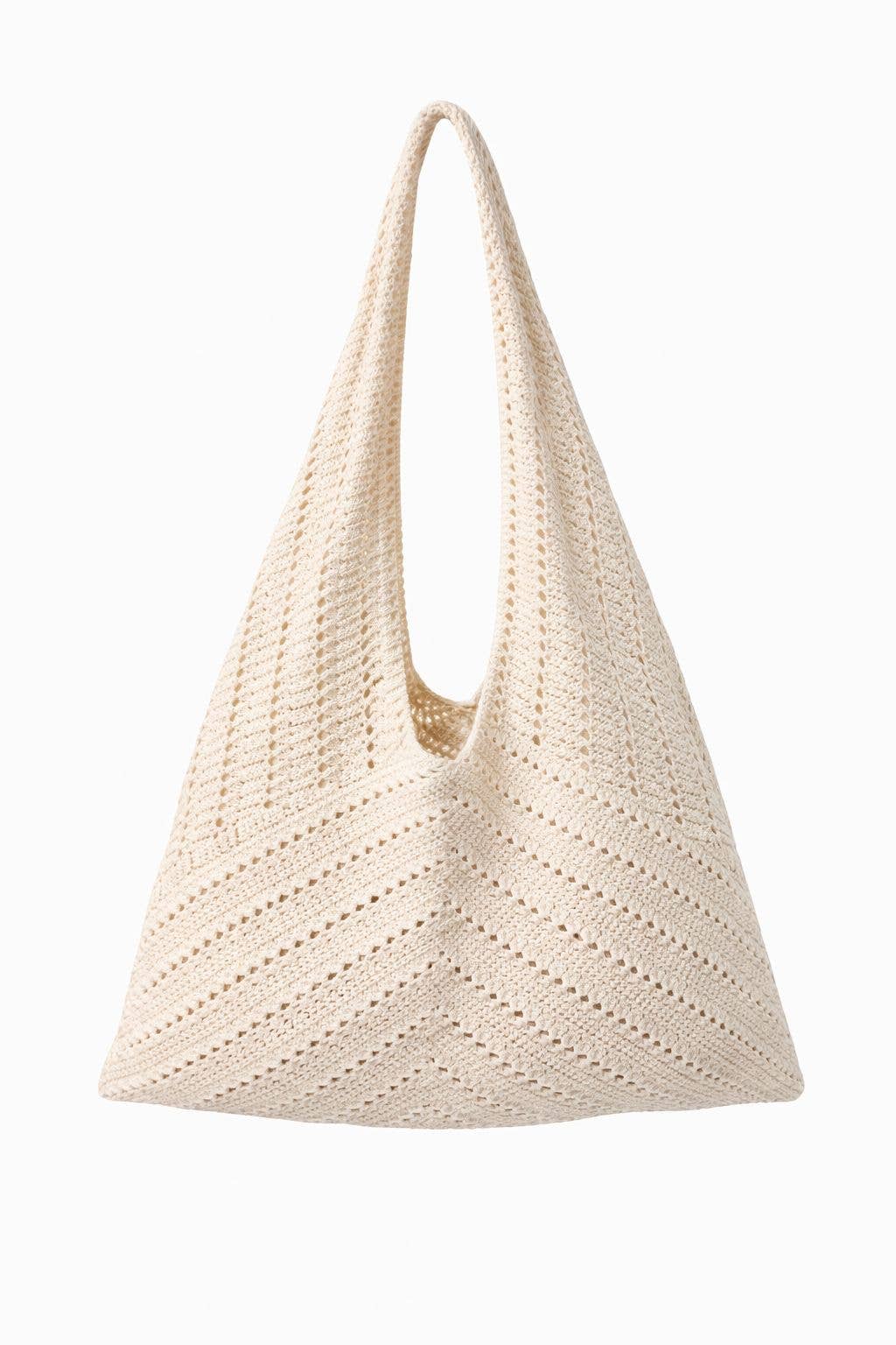 Beige woven handbag on a white background