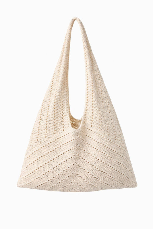 Beige woven handbag on a white background